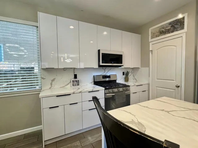 a kitchen with a sink stove and refrigerator