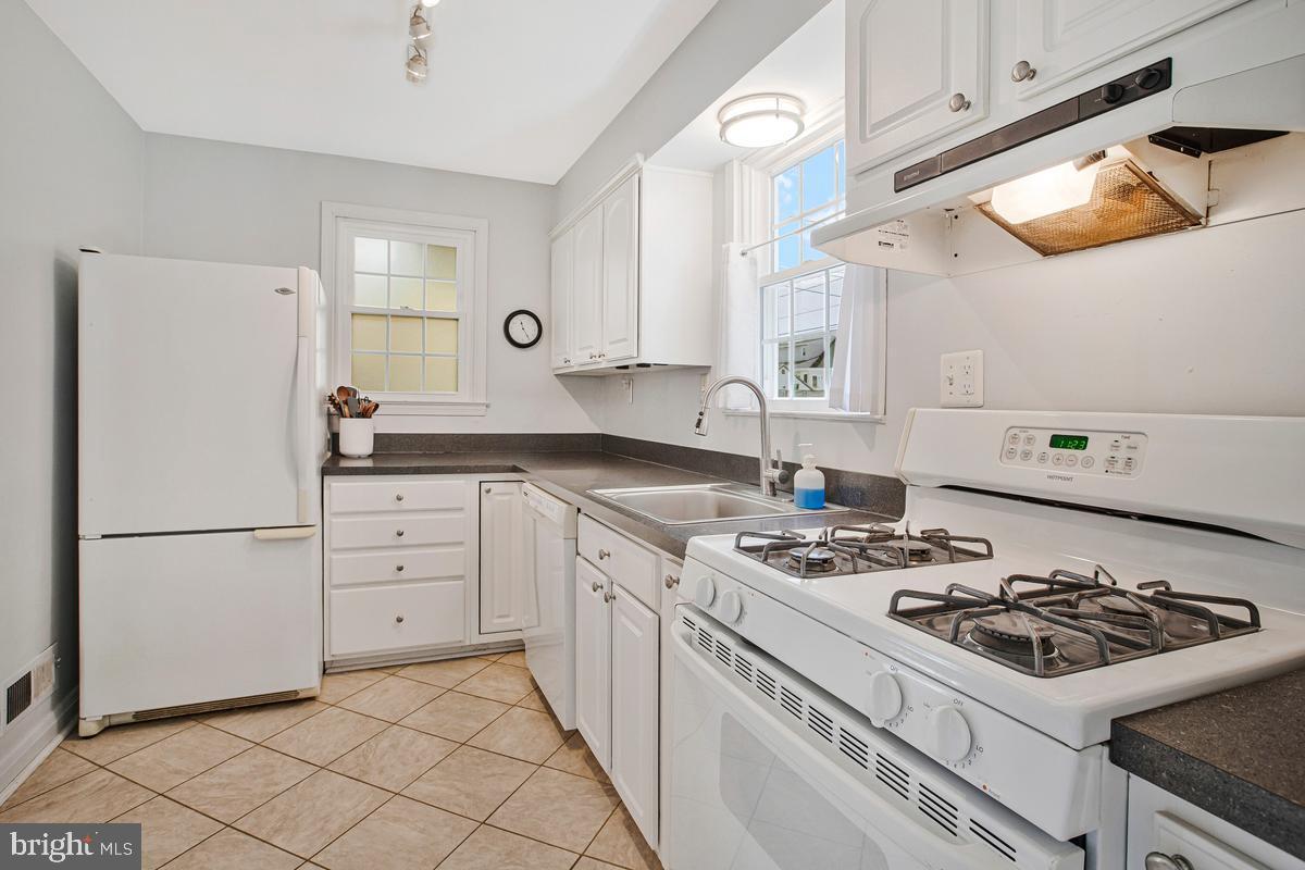 601 Forest View Road Linthicum Heights, MD 21090 - Photo 11 of 37 a kitchen with a stove a refrigerator and a sink