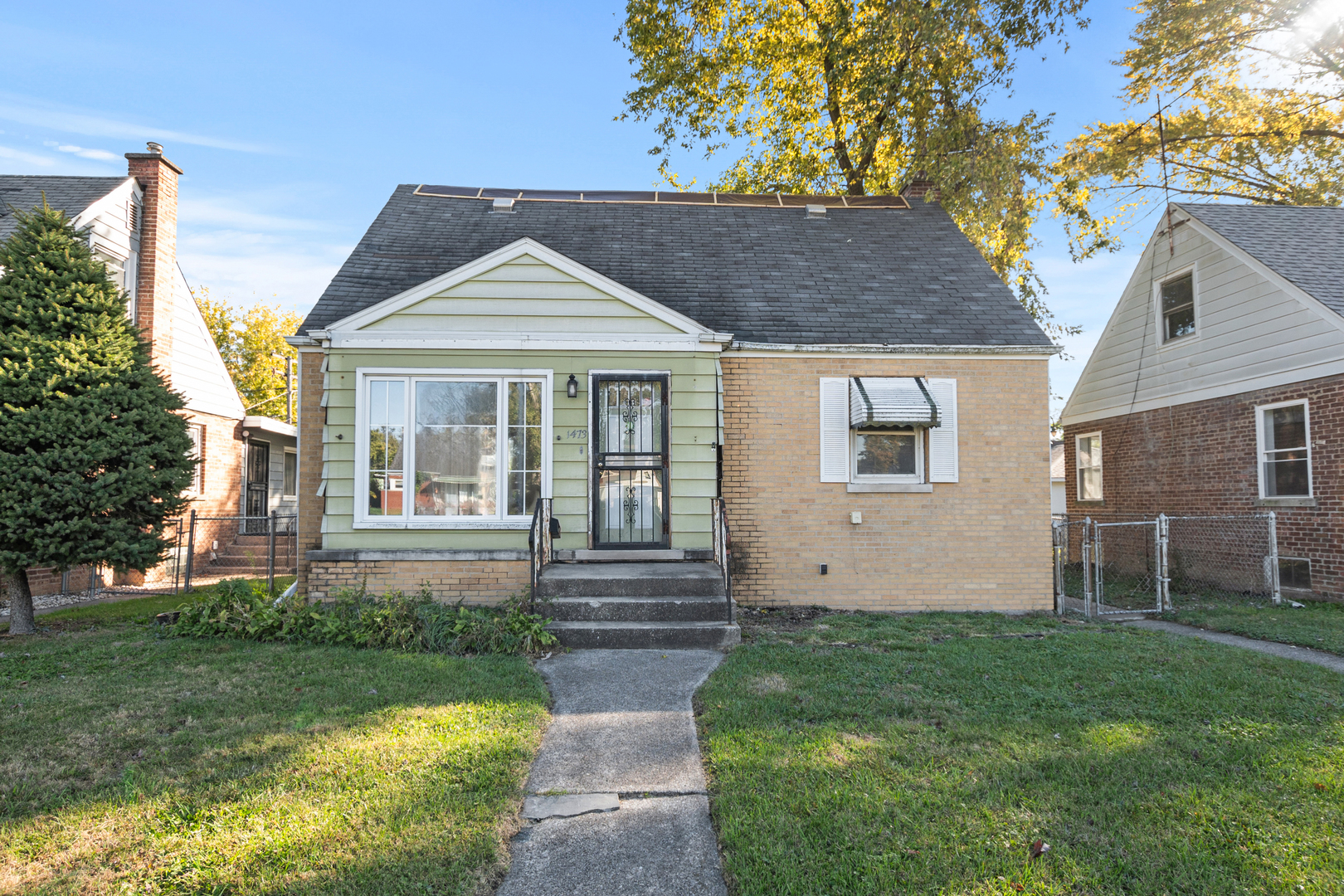 1473 Wentworth Avenue Calumet City, IL 60409 - Photo 1 of 18 a front view of a house with a yard