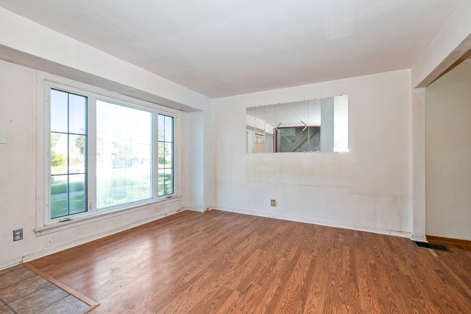 1473 Wentworth Avenue Calumet City, IL 60409 - Photo 5 of 18 an empty room with wooden floor and windows