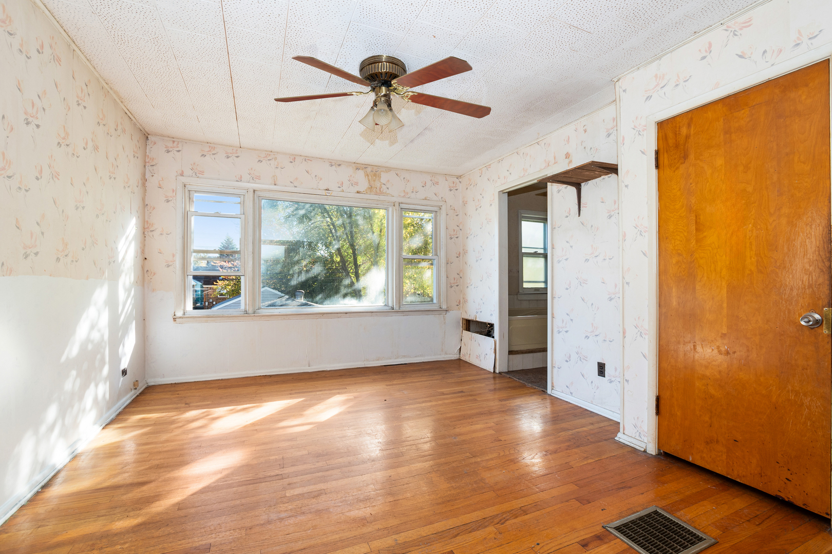 1473 Wentworth Avenue Calumet City, IL 60409 - Photo 6 of 18 wooden floor in an empty room with a window