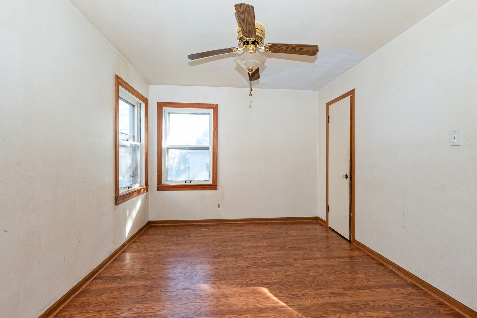 1473 Wentworth Avenue Calumet City, IL 60409 - Photo 7 of 18 a view of empty room with wooden floor and fan