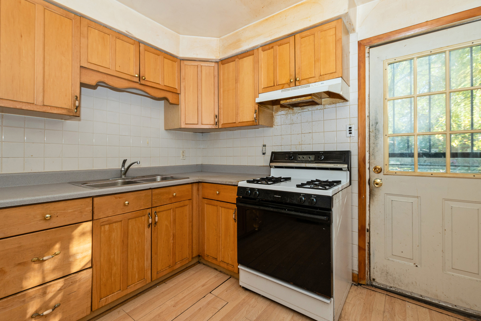 1473 Wentworth Avenue Calumet City, IL 60409 - Photo 8 of 18 a kitchen with granite countertop cabinets stainless steel appliances and a window