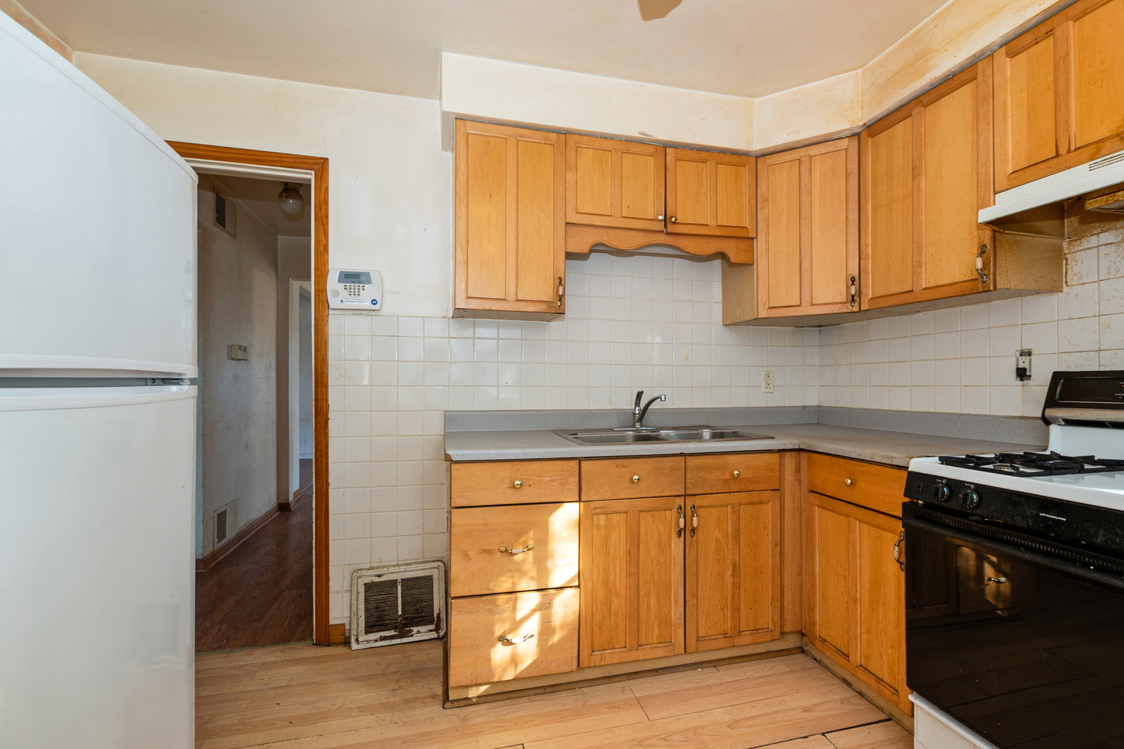 1473 Wentworth Avenue Calumet City, IL 60409 - Photo 9 of 18 a kitchen with stainless steel appliances granite countertop a sink stove and refrigerator