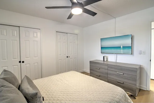 a bedroom with a bed and a chandelier