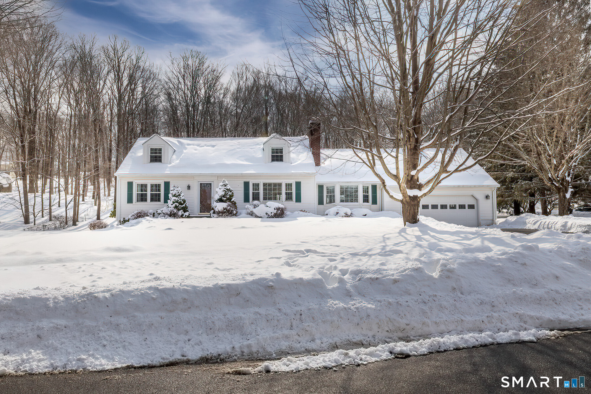 35 Highview Drive Ridgefield, CT 06877 - Photo 1 of 35 a front view of a house with a yard covered in snow