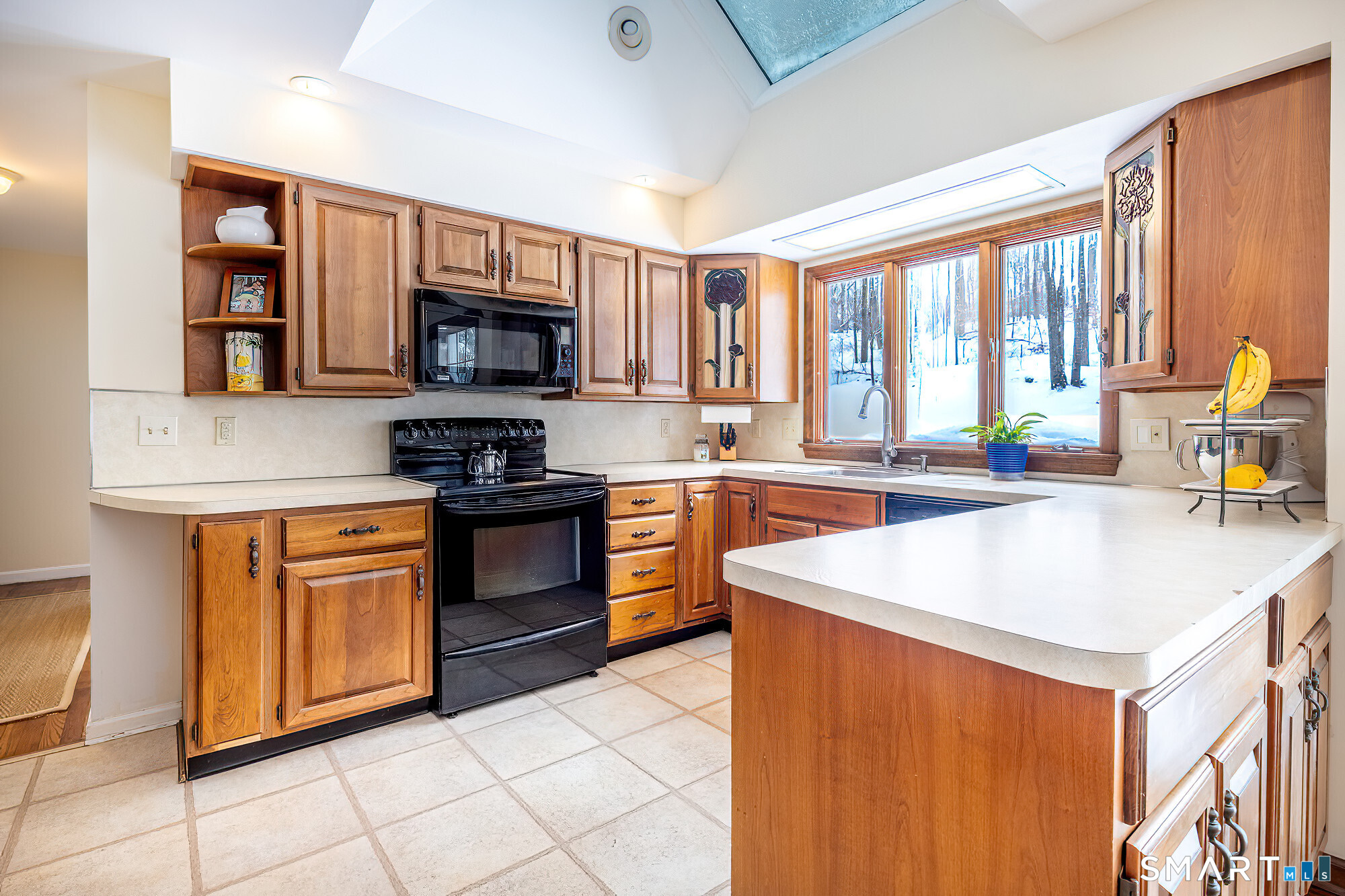 35 Highview Drive Ridgefield, CT 06877 - Photo 8 of 35 a kitchen with stainless steel appliances granite countertop a stove top oven a sink a counter top space and a view of living room