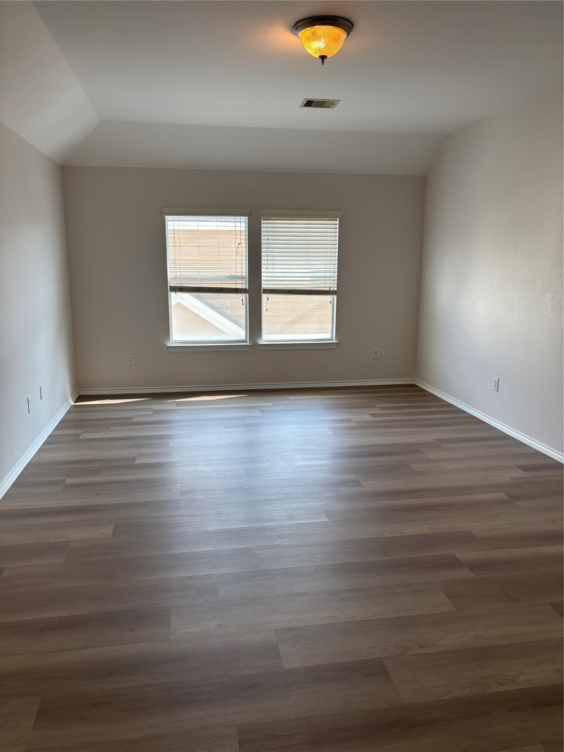 1417 Paige Street Houston, TX 77003 - Photo 12 of 21 an empty room with wooden floor and windows