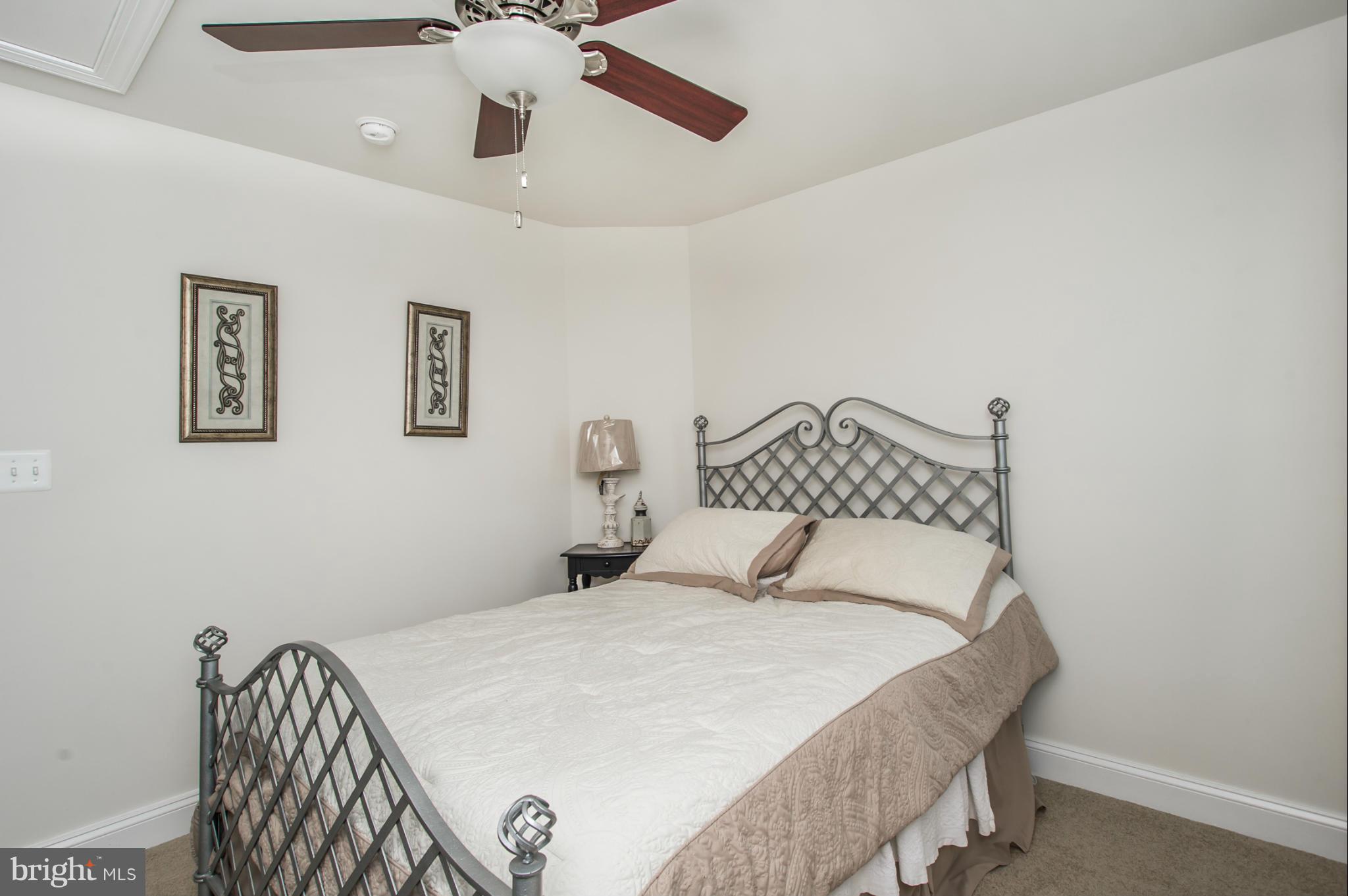 10545 Windlass Run Road Baltimore, MD 21220 - Photo 22 of 30 a bedroom with a bed and a chandelier