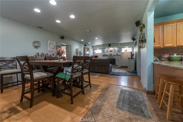 a kitchen with stainless steel appliances kitchen island granite countertop a refrigerator and a sink