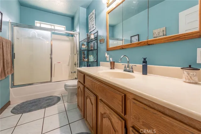 a bedroom with a bed and a chandelier fan