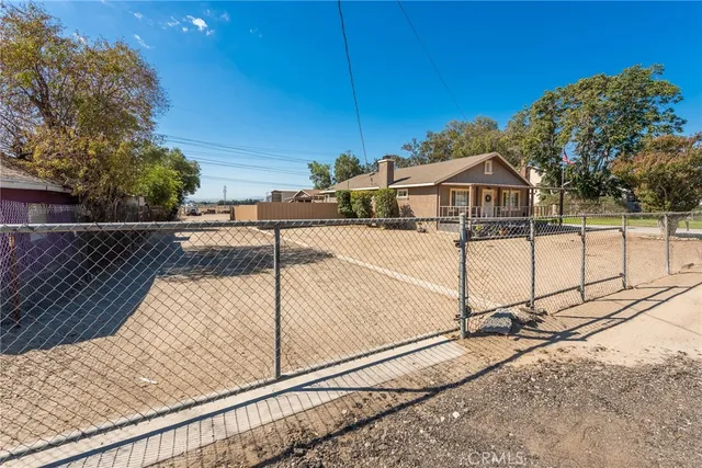 a patio area with table and chairs a barbeque