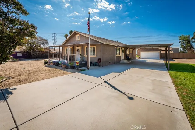 a view of a house with pool and chairs