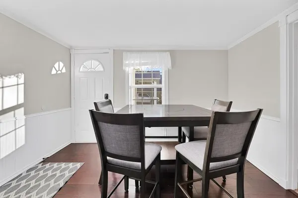 a view of a dining room with furniture and wooden floor
