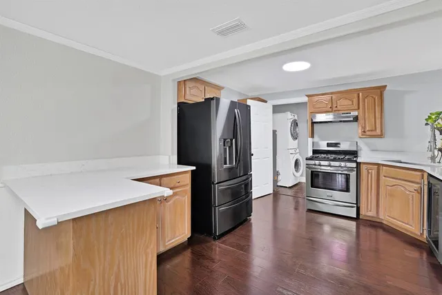 a kitchen with granite countertop a refrigerator stove and oven