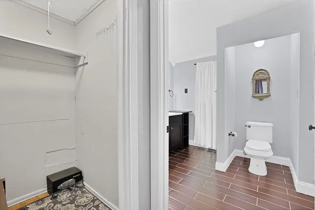 a bathroom with a toilet and a shower