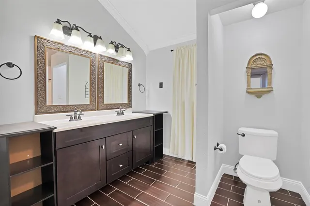 a bathroom with a double vanity sink and a mirror