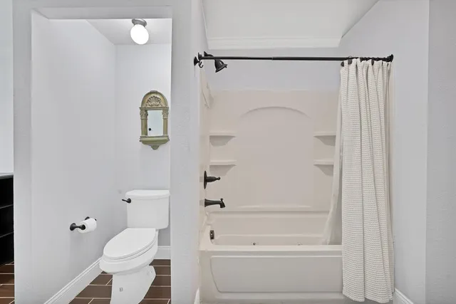 a bathroom with a shower a toilet and a sink