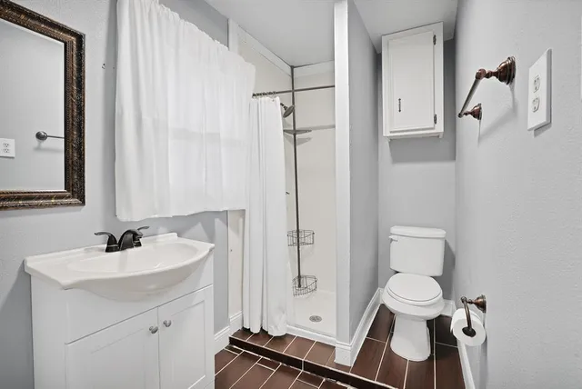 a bathroom with a sink toilet and shower