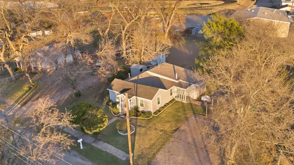 a dirty bathroom with a granite countertop shower and a mirror