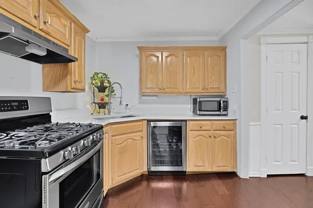 a kitchen with stainless steel appliances granite countertop a stove and a refrigerator