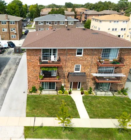 front view of a brick house with a yard