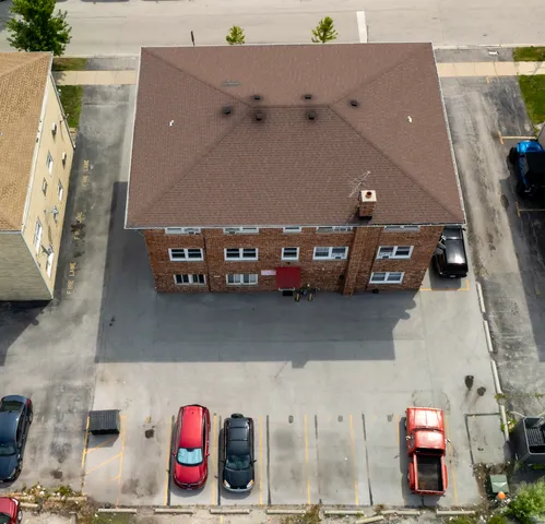 a bedroom with a bed a chandelier and dresser