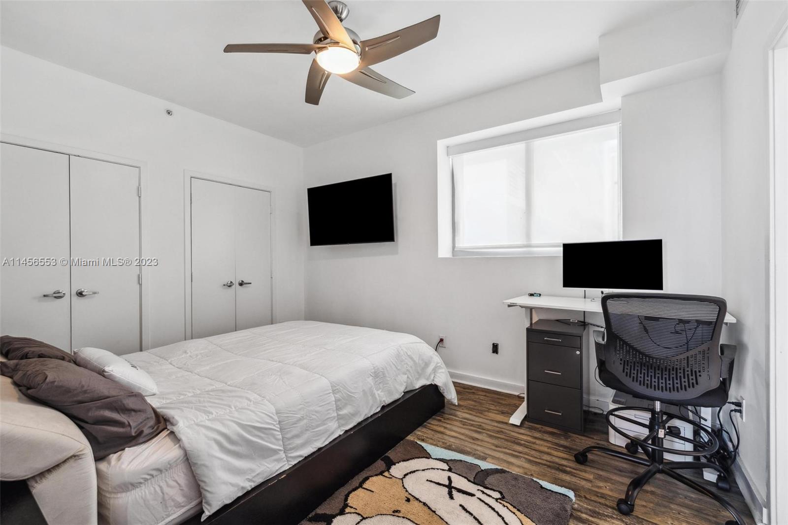 888 Biscayne Boulevard, Unit 1809 Miami, FL 33132 - Photo 19 of 37 a bedroom with a bed and a flat screen tv