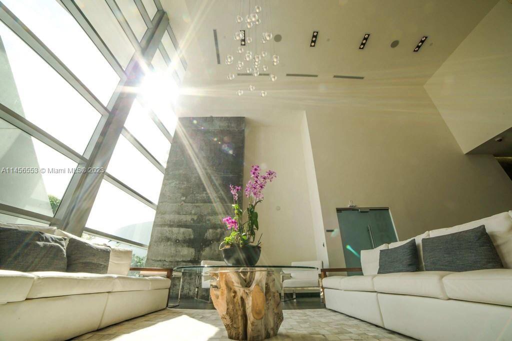 888 Biscayne Boulevard, Unit 1809 Miami, FL 33132 - Photo 25 of 37 a living room with furniture and a window