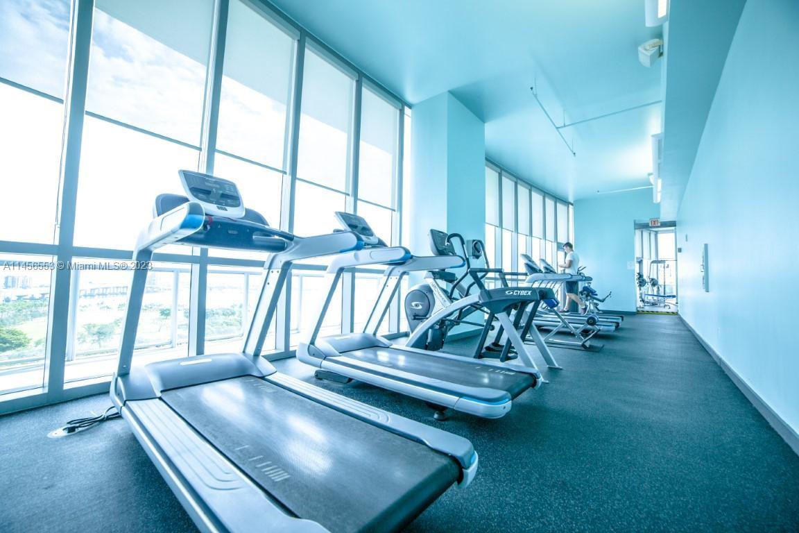 888 Biscayne Boulevard, Unit 1809 Miami, FL 33132 - Photo 31 of 37 a view of a room with gym equipment
