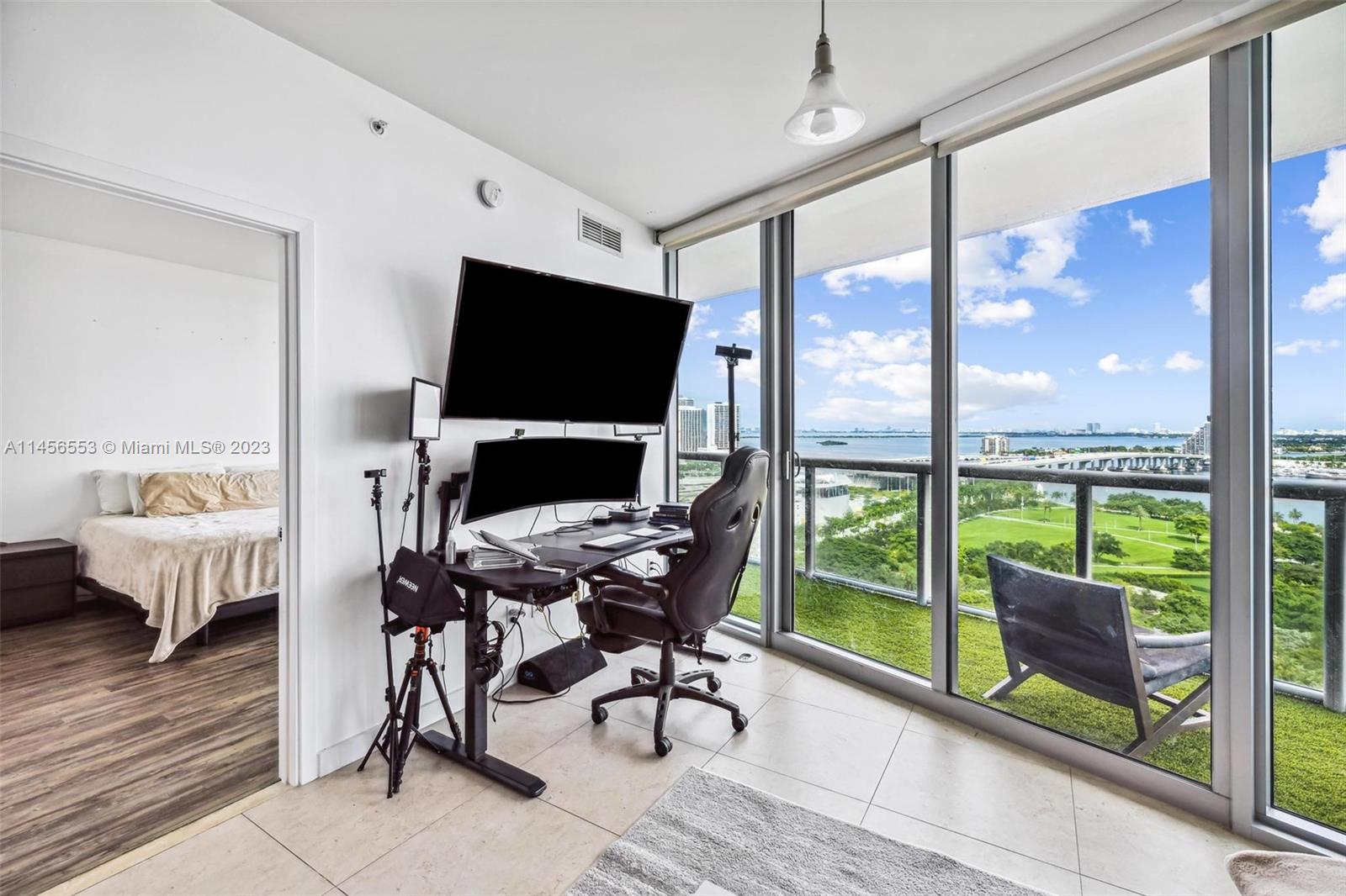 888 Biscayne Boulevard, Unit 1809 Miami, FL 33132 - Photo 34 of 37 a view of a workspace with furniture and a window