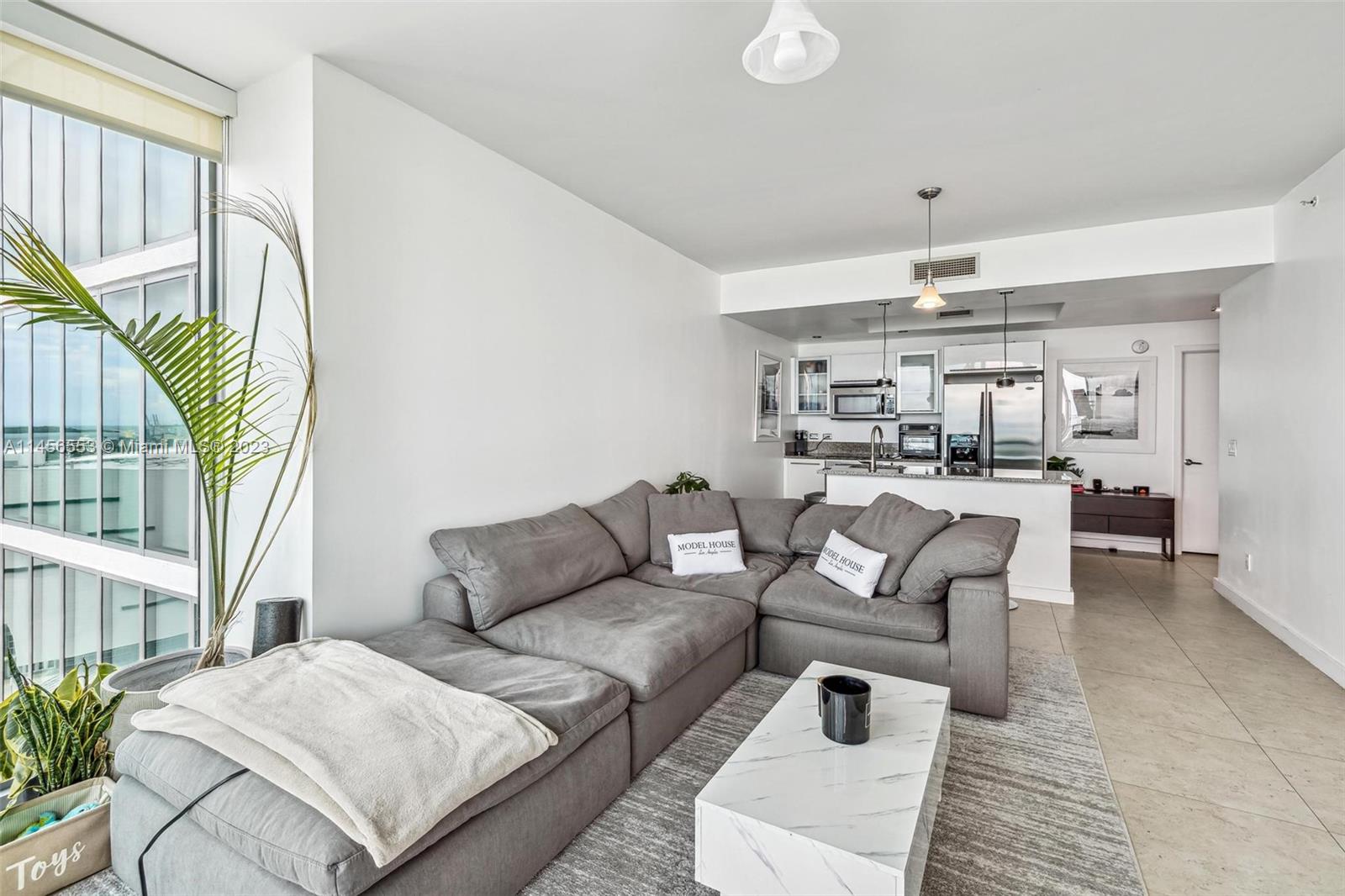 888 Biscayne Boulevard, Unit 1809 Miami, FL 33132 - Photo 5 of 37 a living room with furniture and a chandelier