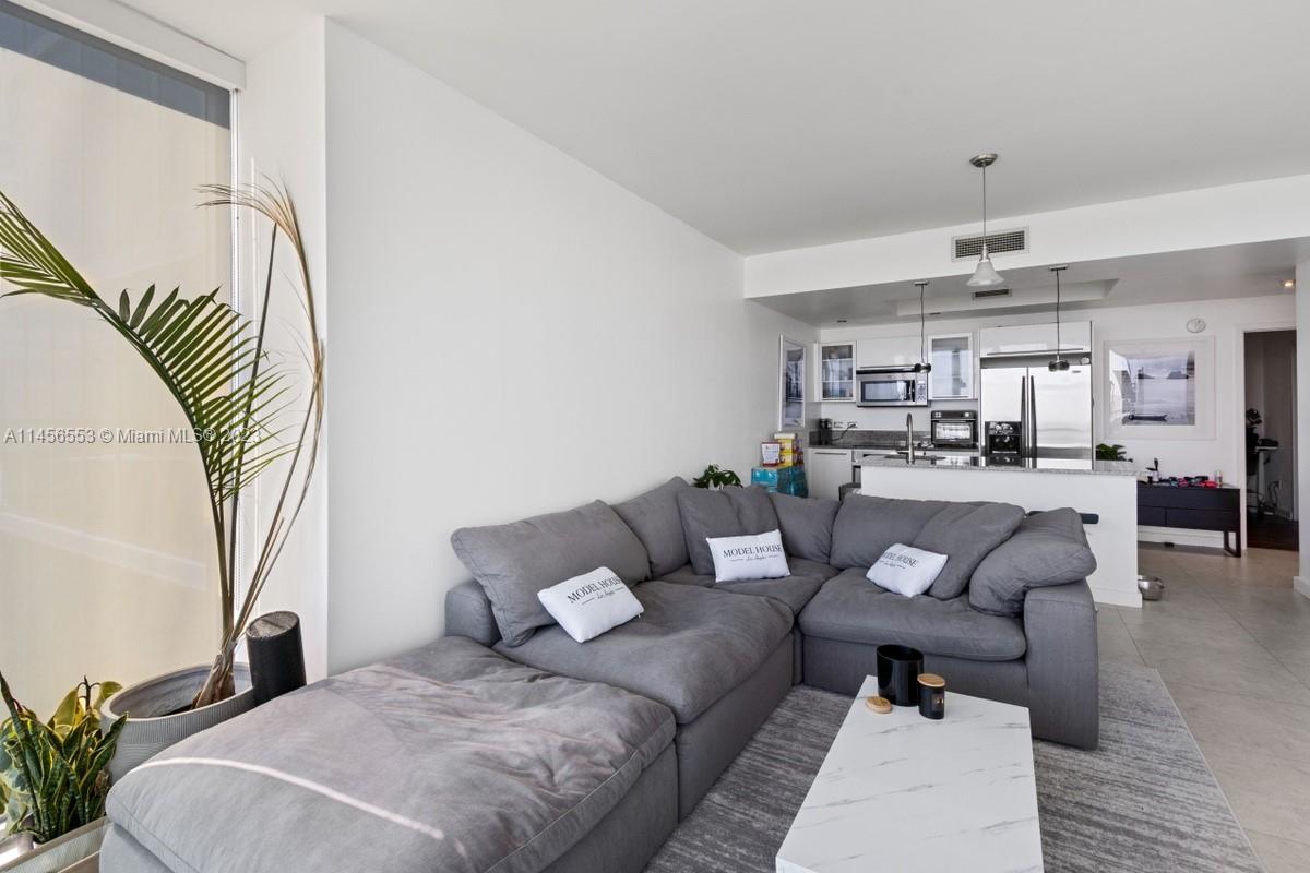 888 Biscayne Boulevard, Unit 1809 Miami, FL 33132 - Photo 6 of 37 a living room with furniture and kitchen view