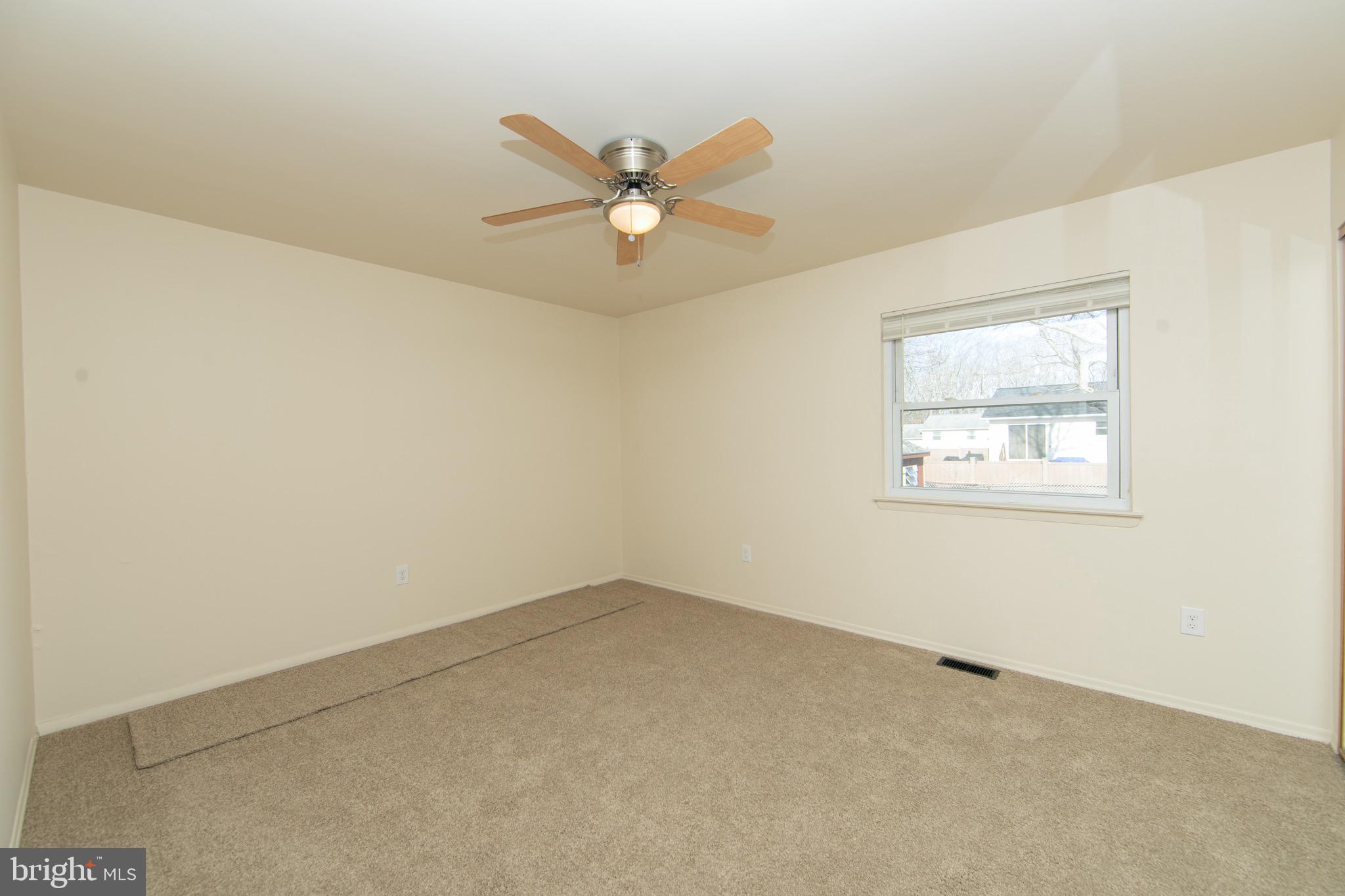 608 Katherine Road Browns Mills, NJ 08015 - Photo 12 of 42 an empty room with a window and a fan