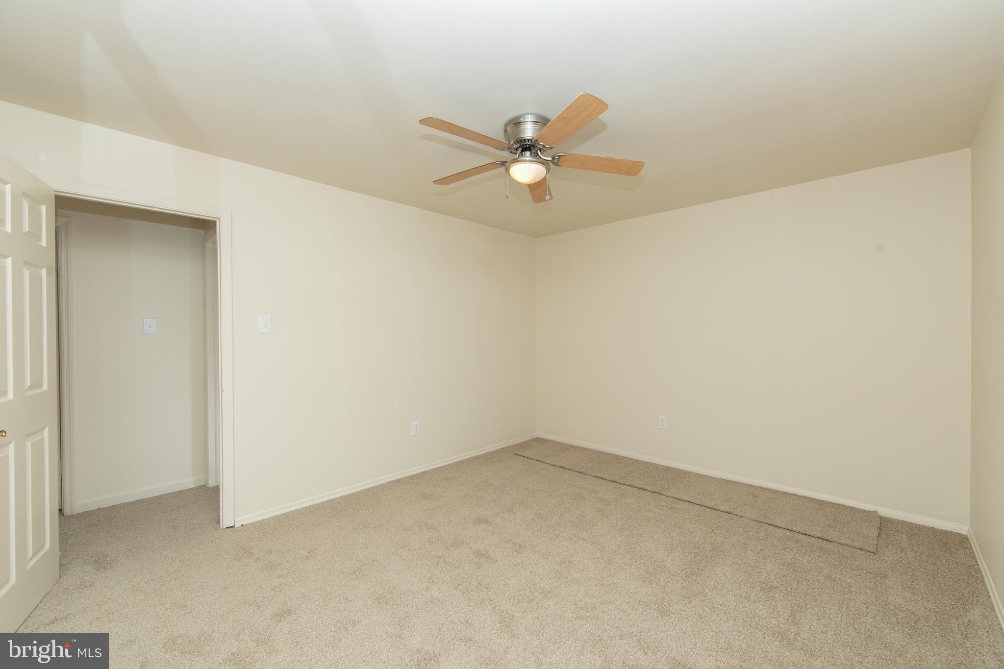 608 Katherine Road Browns Mills, NJ 08015 - Photo 14 of 42 an empty room with a window and a ceiling fan