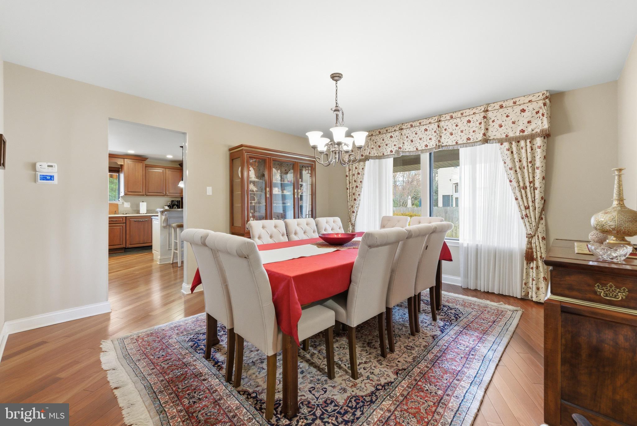 3 Stonehurst Drive Voorhees, NJ 08043 - Photo 14 of 43 a dining room with wooden floor a chandelier a wooden table and chairs