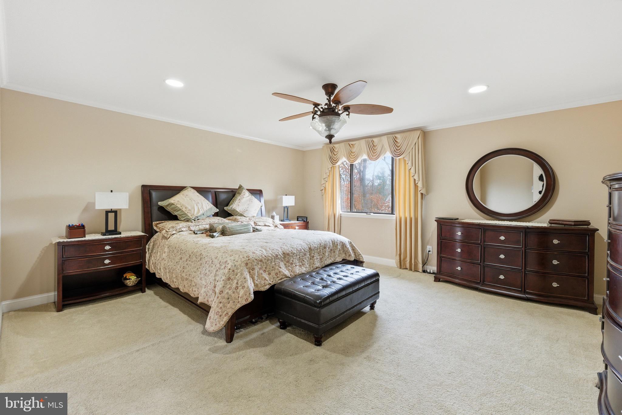 3 Stonehurst Drive Voorhees, NJ 08043 - Photo 20 of 43 a spacious bedroom with a bed a dresser and a chandelier