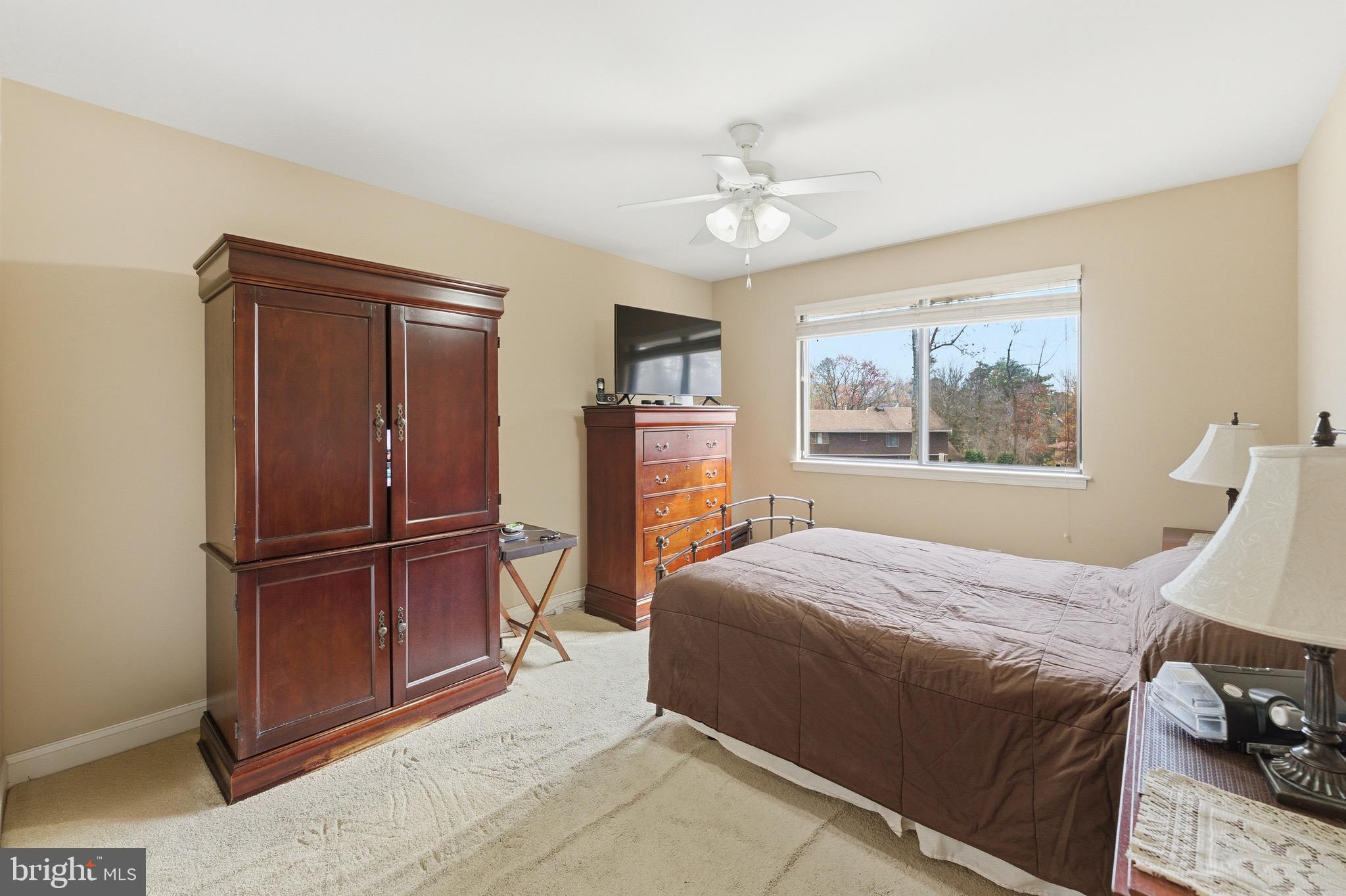 3 Stonehurst Drive Voorhees, NJ 08043 - Photo 25 of 43 a bedroom with a bed and a chandelier