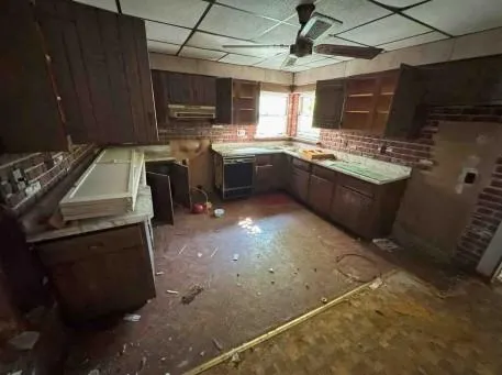 a kitchen with a sink appliances and cabinets