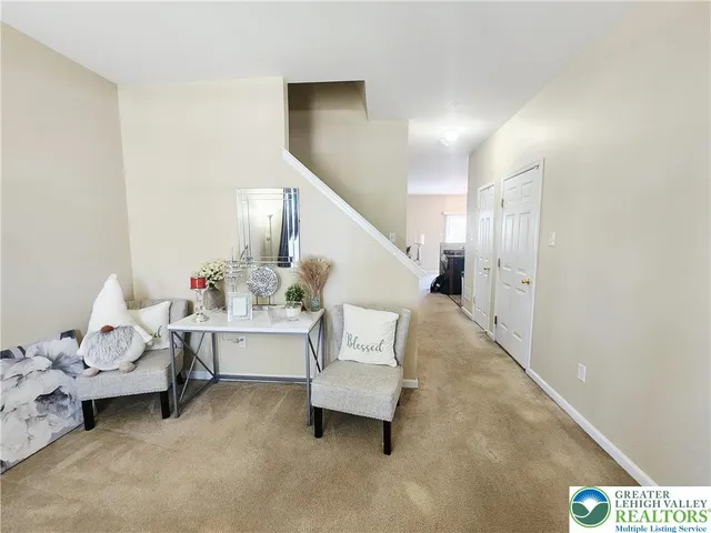 a living room with furniture and white walls