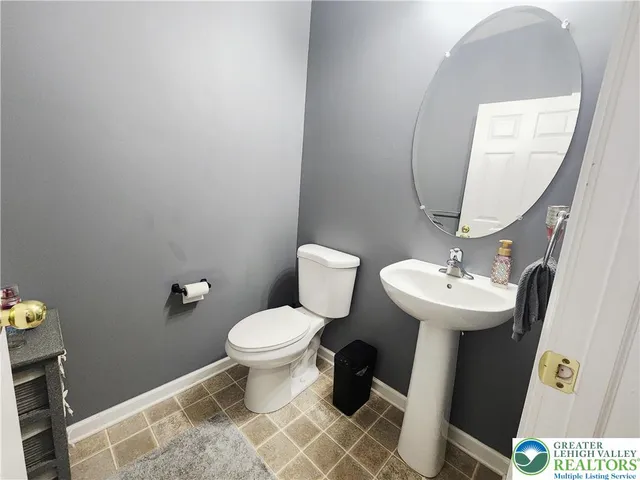 a bathroom with a sink toilet and a mirror