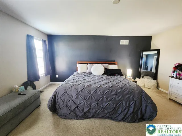 a bedroom with a bed and window