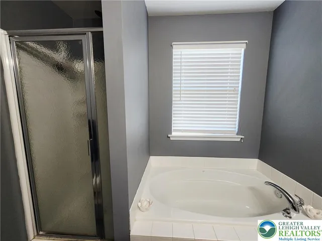 a white bath tub sitting next to a window