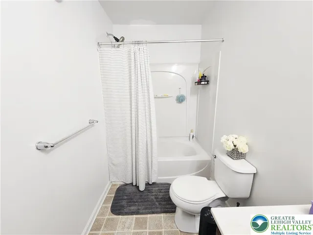 a bathroom with a toilet sink and shower