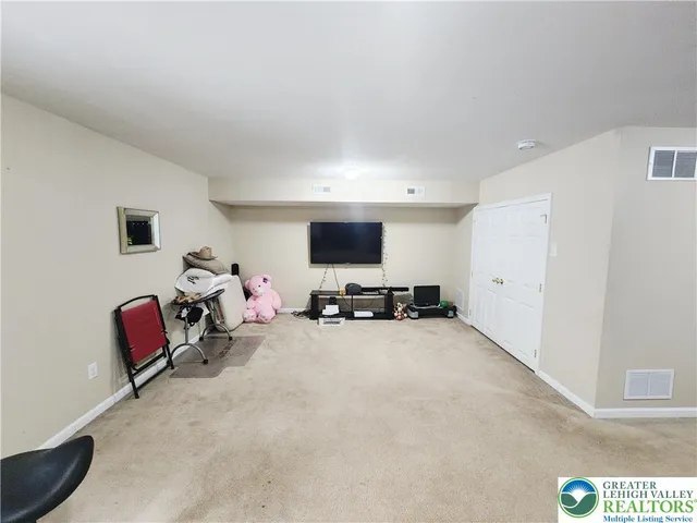 a view of a livingroom with workspace and a couch