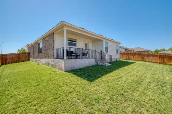 a front view of house with yard and seating area