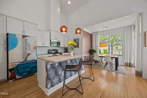 a kitchen with stainless steel appliances granite countertop a stove a sink dishwasher and a microwave with wooden floor