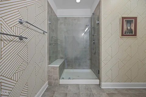 a bathroom with a granite countertop sink mirror and shower