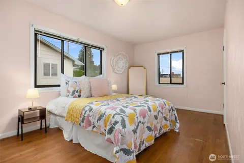 a bedroom with a large bed and a window