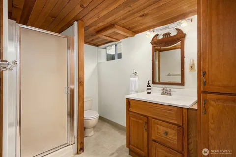 a bathroom with a sink and mirror with toilet
